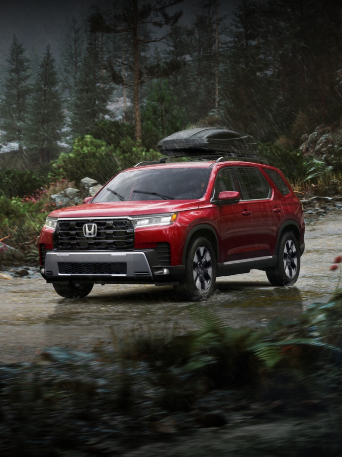 2026 Honda Pilot Elite shown in Radiant Red Metallic II with Honda Genuine Accessories