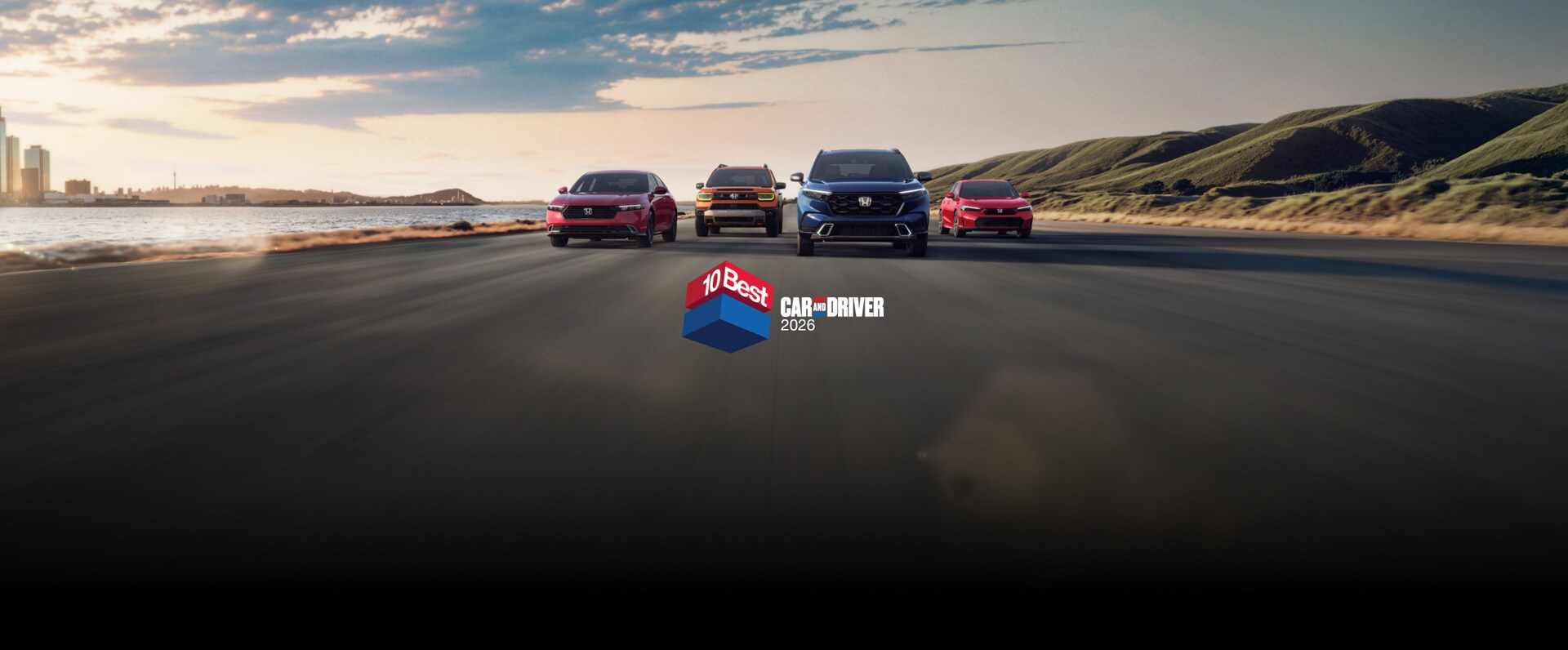 2026 Honda Accord, Passport, CR-V and Civic Sedan front view driving on a coastal street with overlapping Car and Driver 10Best logo
