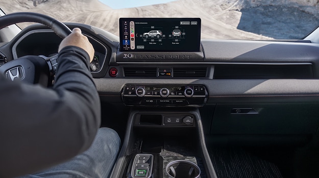 2026 Honda Passport TrailSport interior detail of the dashboard featuring the infotainment screen and center console.