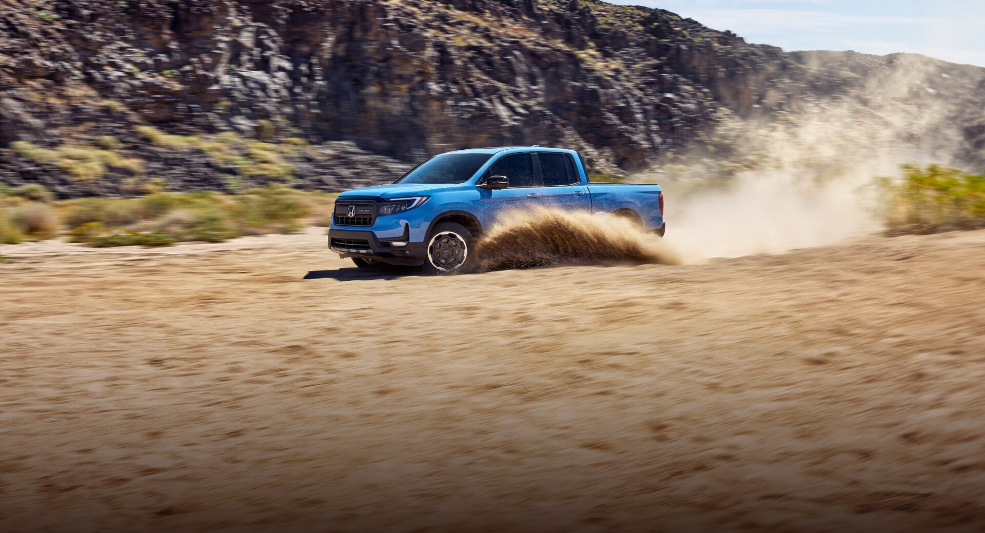 2025 Honda Ridgeline in Diffused Sky Blue Pearl on a dirt road