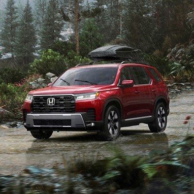 2026 Honda Pilot Elite shown in Radiant Red Metallic II with Honda Genuine Accessories