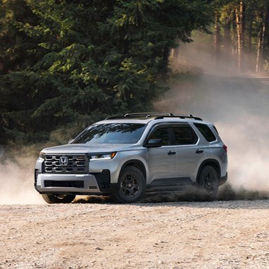 2026 Honda Pilot TrailSport shown in Solar Silver Metallic with Honda Genuine Accessories.
