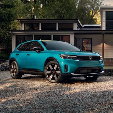 2026 Honda Prologue Elite in North Shore Pearl, parked outside a home amongst the redwood trees.