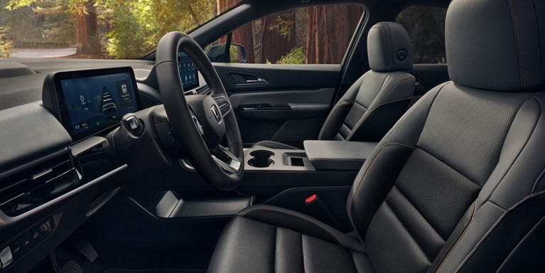 2026 Honda Prologue Elite interior, featuring the cabin, dashboard, steering wheel, and seating area from a side view.