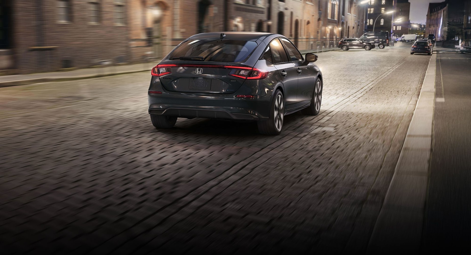 2026 Honda Civic Hatchback Sport Touring Hybrid in Meteorite Gray Metallic highlighting rear fastback attributes