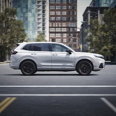 2026 CR-V e:FCEV in Platinum White Pearl drifing in a city