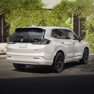 Rear Passenger view, LED Taillight and "e:" badge detail of 2026 CR-V e:FCEV in Platinum White Pearl , showing new bumper and no exhaustparked in a clean urban location, with greenery.