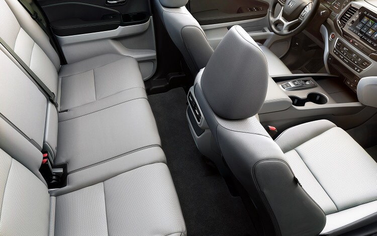 2026 Honda Ridgeline RTL with gray leather interior, showing rear and front seats.