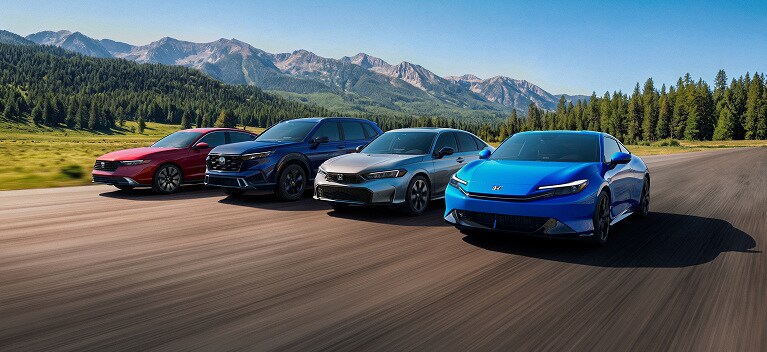 2026 Honda Hybrid Models Packshot driving along a scenic mountain road with a forest backdrop.