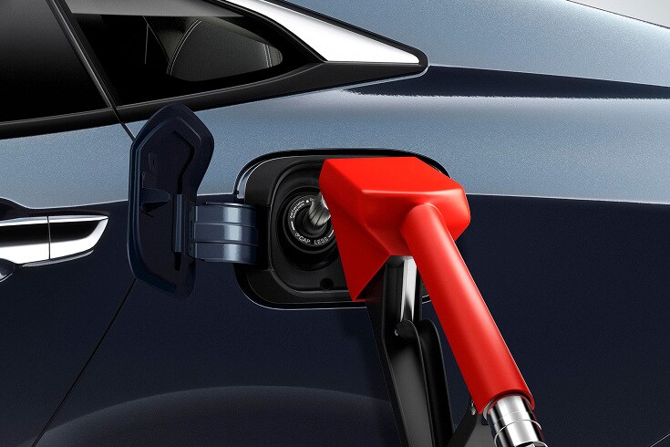 2026 Honda Civic Sedan in Blue Lagoon Pearl profile studio showing the capless fuel filler (Compact Sedan).