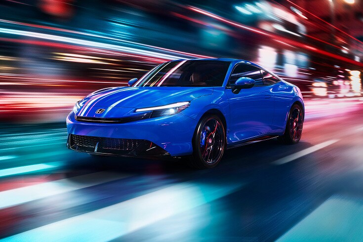2026 Honda Prelude in Boost Blue Pearl front city street with motion blur (exhilarating hybrid coupe).